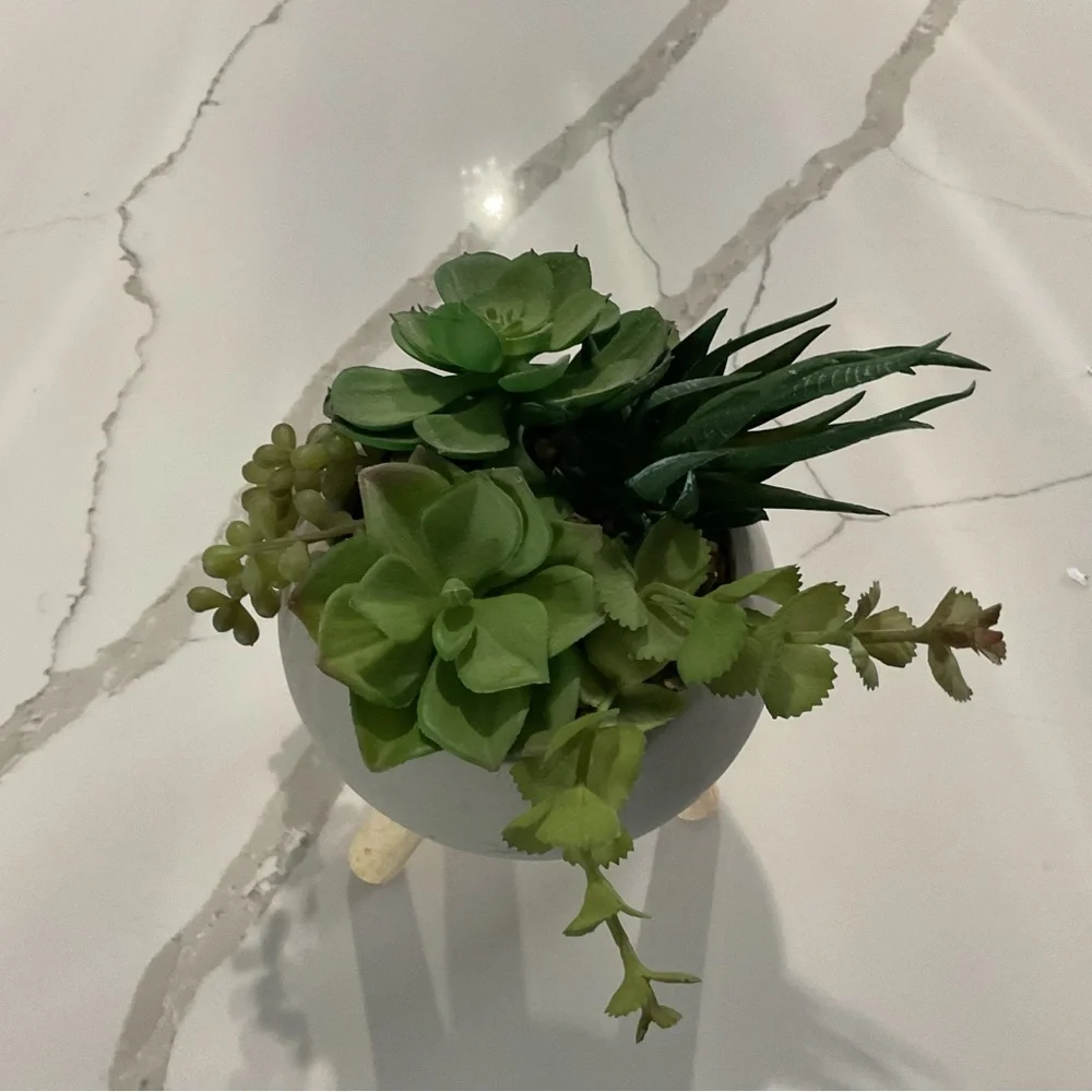 Chic Gray Planter with Wooden Legs and Lush Green Faux Succulents